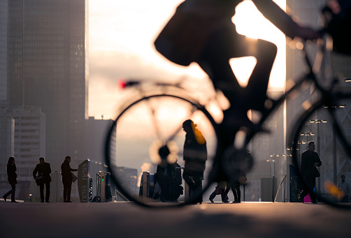 Businessman on bicycle passing skyline La Defense